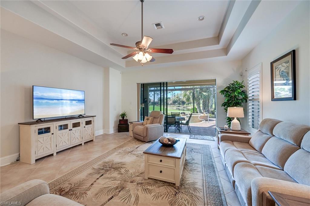 7587 Moorgate Point Way Naples, FL 34113 - Photo 5 of 47 a living room with furniture and a flat screen tv