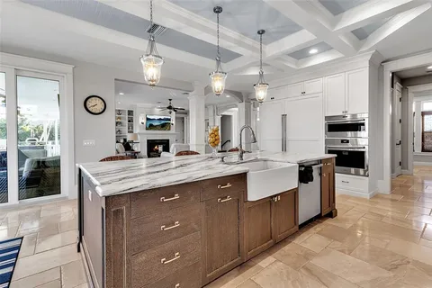 a bedroom with a bed a dresser and wooden floor
