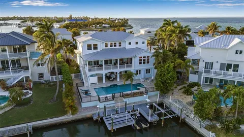 a living room with furniture a fireplace and a large window