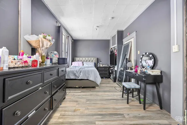 a bedroom with furniture and a wooden floor