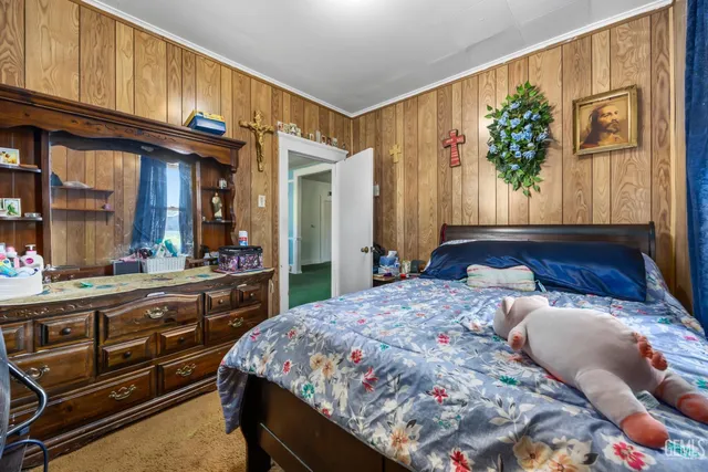 a bedroom with a bed and a large window