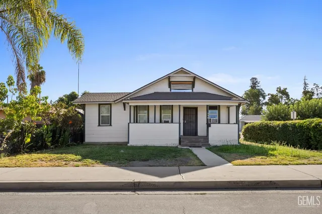 a front view of a house with a yard and a garage