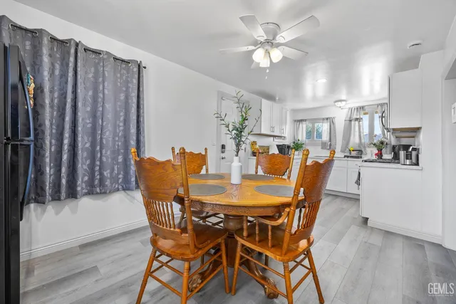 a view of a dining room with furniture and chandelier