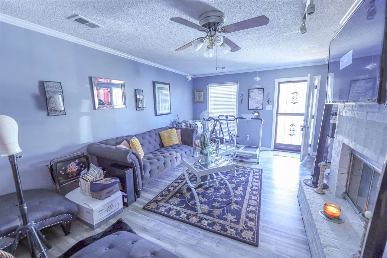 4199 Cedartree Drive Memphis, TN 38141 - Photo 2 of 12 a living room with furniture and a fireplace