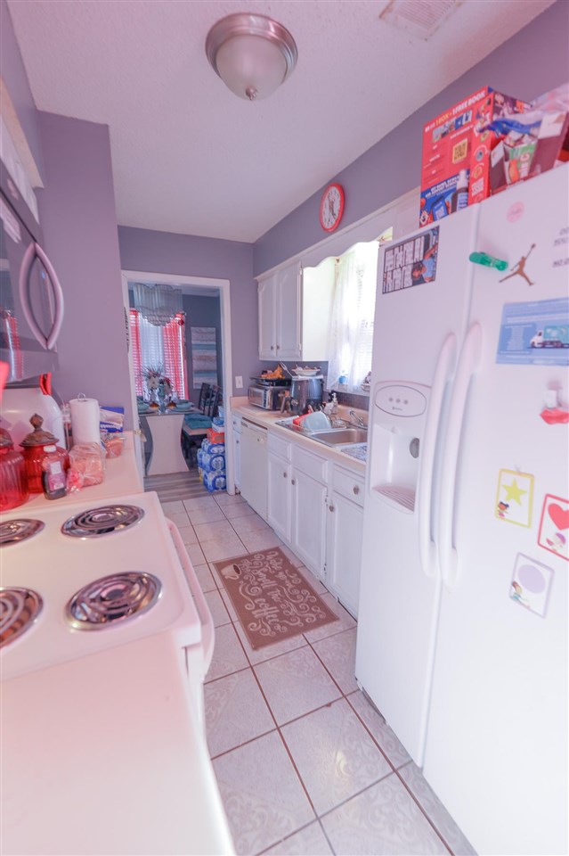 4199 Cedartree Drive Memphis, TN 38141 - Photo 4 of 12 a kitchen with a refrigerator and sink