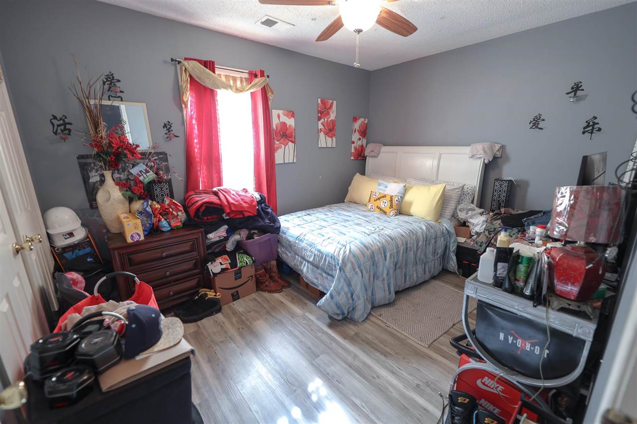 4199 Cedartree Drive Memphis, TN 38141 - Photo 7 of 12 a bedroom with bed and a chandelier