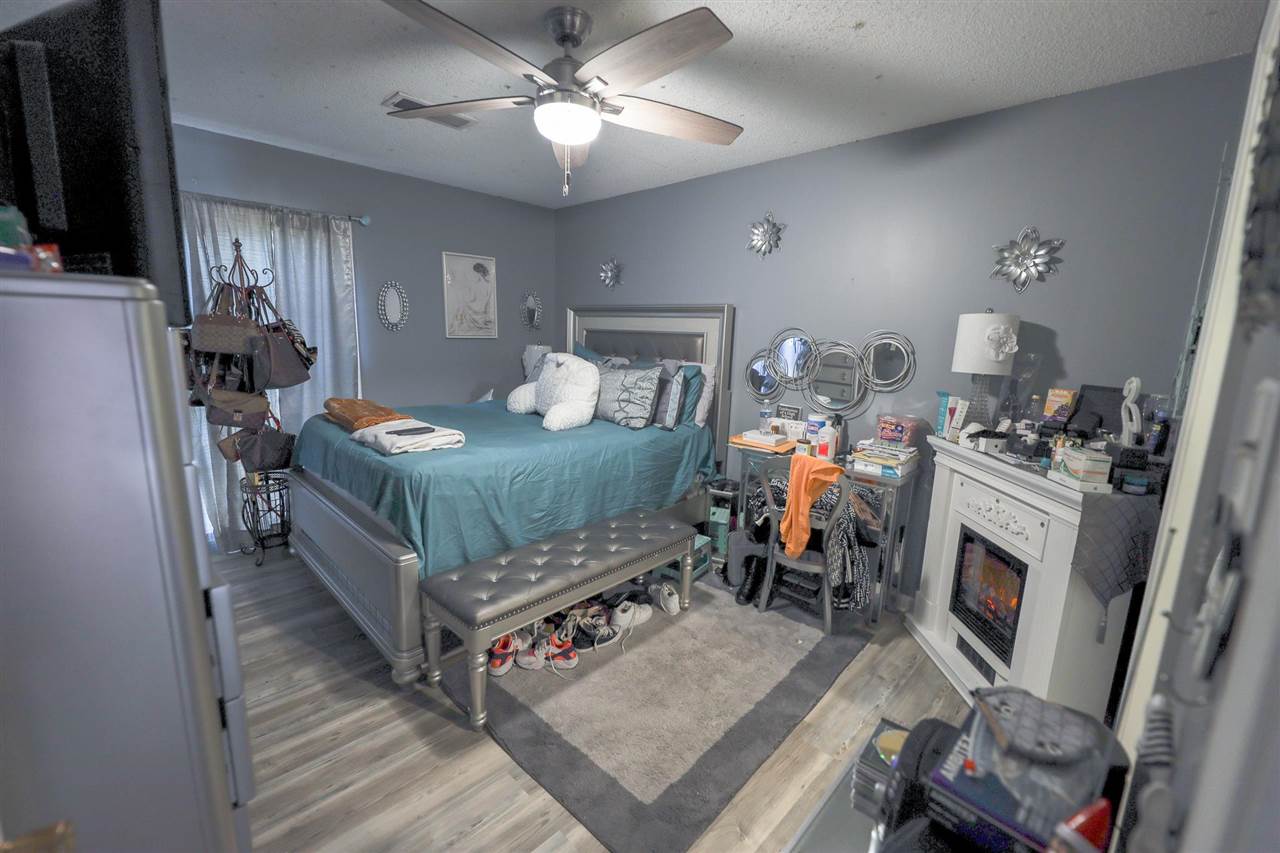 4199 Cedartree Drive Memphis, TN 38141 - Photo 8 of 12 a bed room with furniture and a chandelier