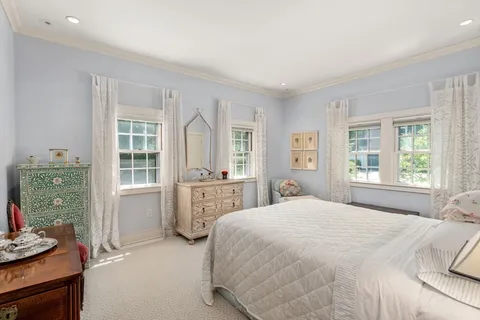 an aerial view of a house with a yard and lake view