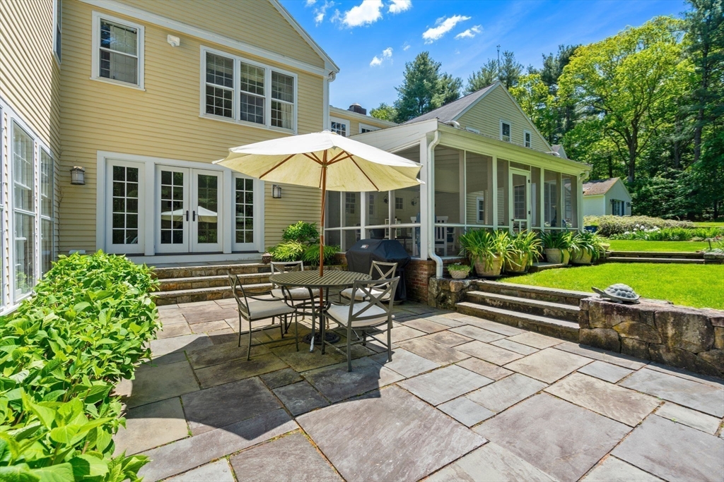 4 Claybrook Road Dover, MA 02030 - Photo 25 of 42 a view of a house with backyard sitting area and garden