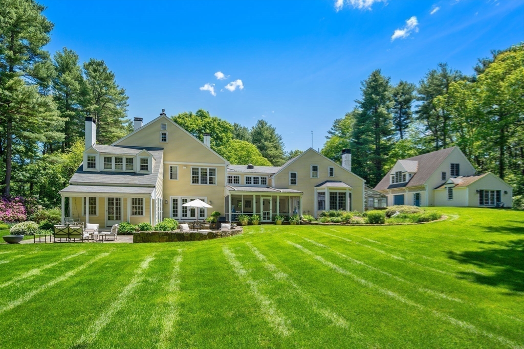 4 Claybrook Road Dover, MA 02030 - Photo 40 of 42 a front view of a house with a garden and trees