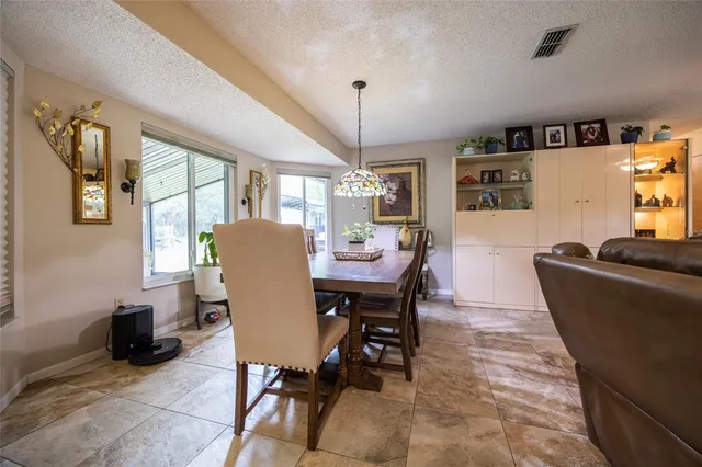 a view of a dining room with furniture and window