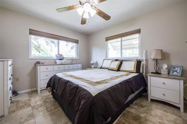 a bedroom with a large bed and a flat tv screen