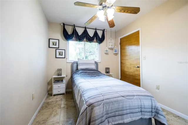 a bedroom with a bed and a window