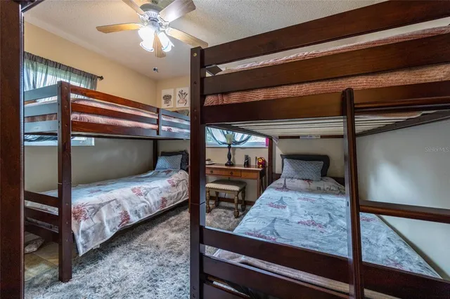 a bedroom with a bed a mirror and furniture