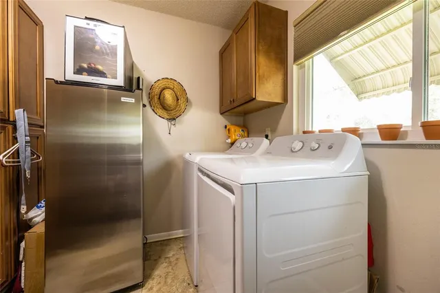 a living room with furniture a flat screen tv and a large window