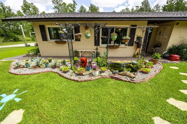 a front view of a house with garden and porch