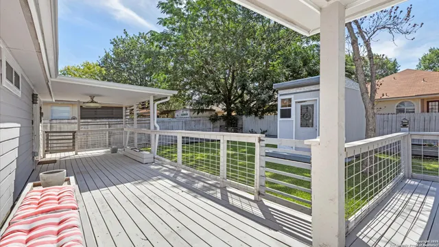 a view of balcony with wooden floor and fence