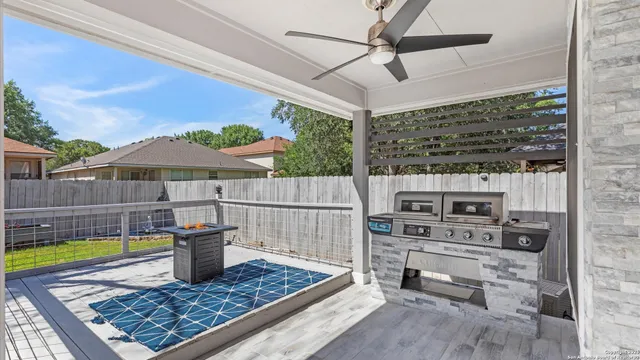 a view of a terrace with a table and chairs