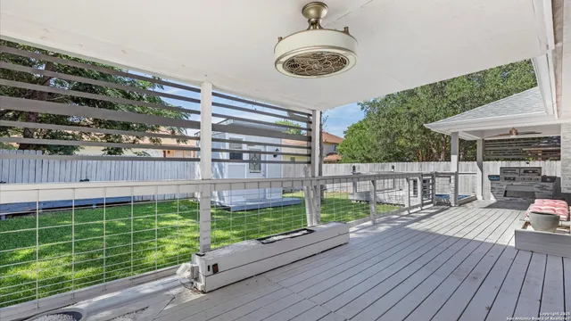a view of a house with a yard and a large tree