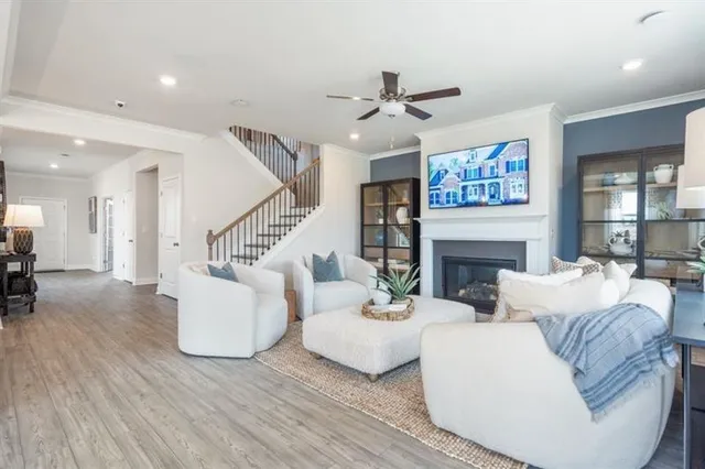 a living room with furniture and a dining table with kitchen view