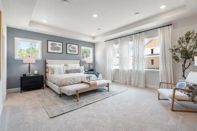 a spacious bedroom with a bed and a couch