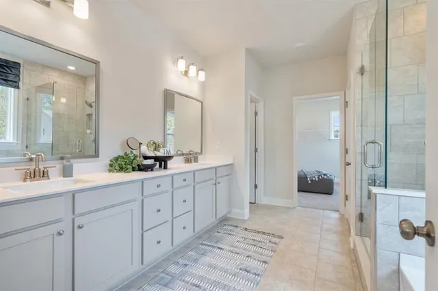 a bathroom with double vanity sinks and a mirror