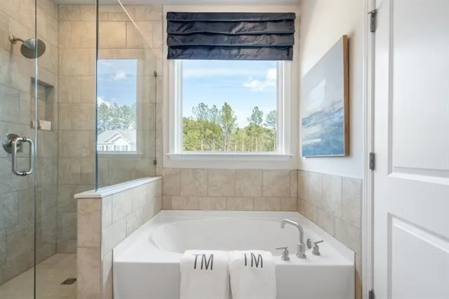 a bathroom with a bathtub and shower