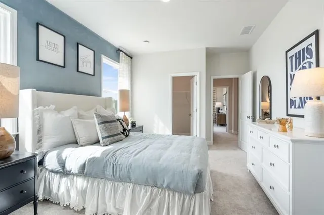 a bedroom with a bed and a lamp