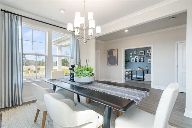 a dining room with furniture a chandelier and wooden floor