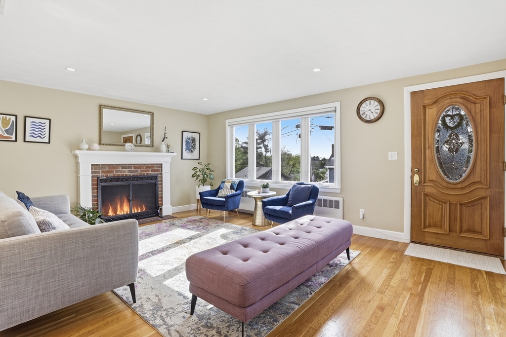 115 Collincote Street Stoneham, MA 02180 - Photo 3 of 25 a living room with furniture and a fireplace