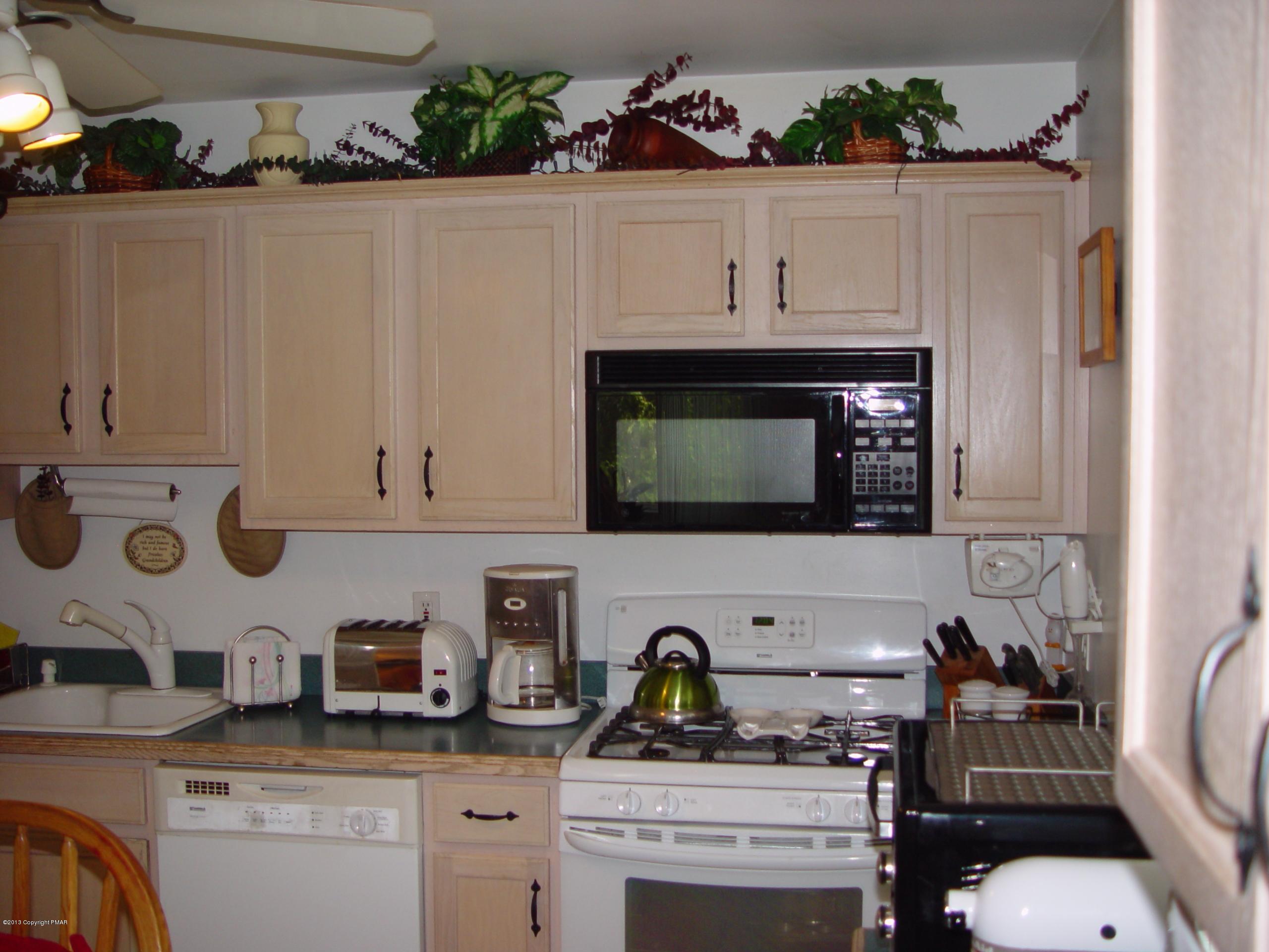 396 Good Times Road Kunkletown, PA 18058 - Photo 25 of 45 a kitchen with stainless steel appliances a stove a white cabinets and a sink