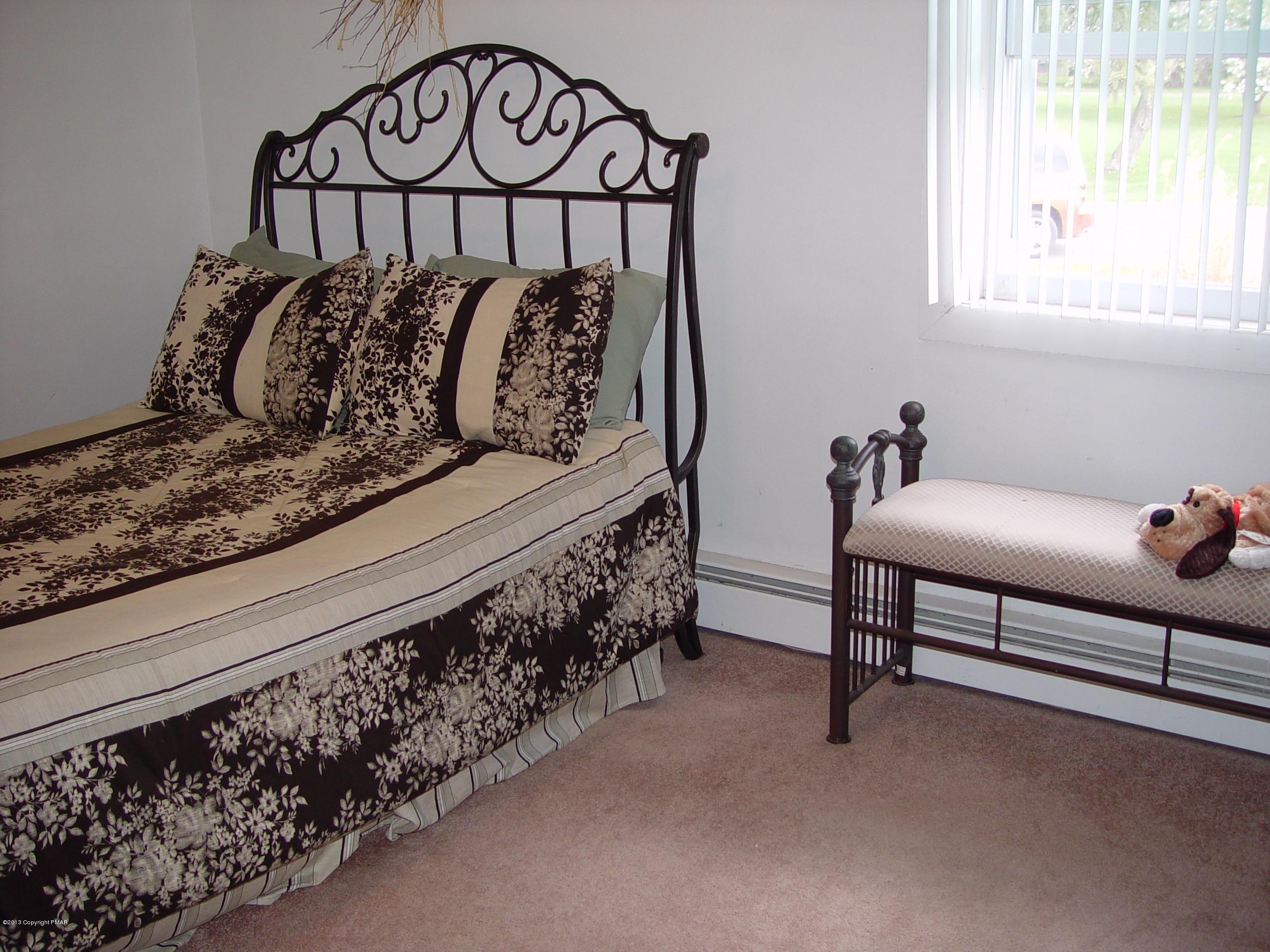 396 Good Times Road Kunkletown, PA 18058 - Photo 31 of 45 a bed sitting in a bedroom next to a window