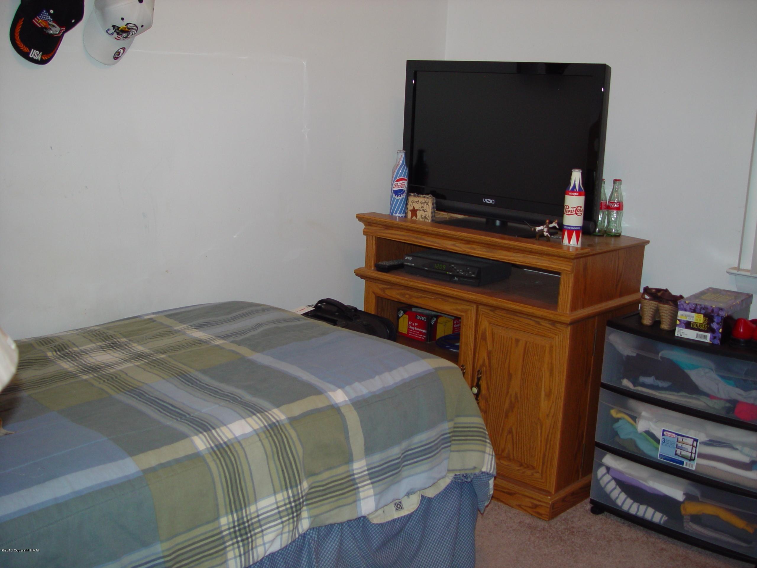396 Good Times Road Kunkletown, PA 18058 - Photo 35 of 45 a bedroom with a bed and a flat screen tv