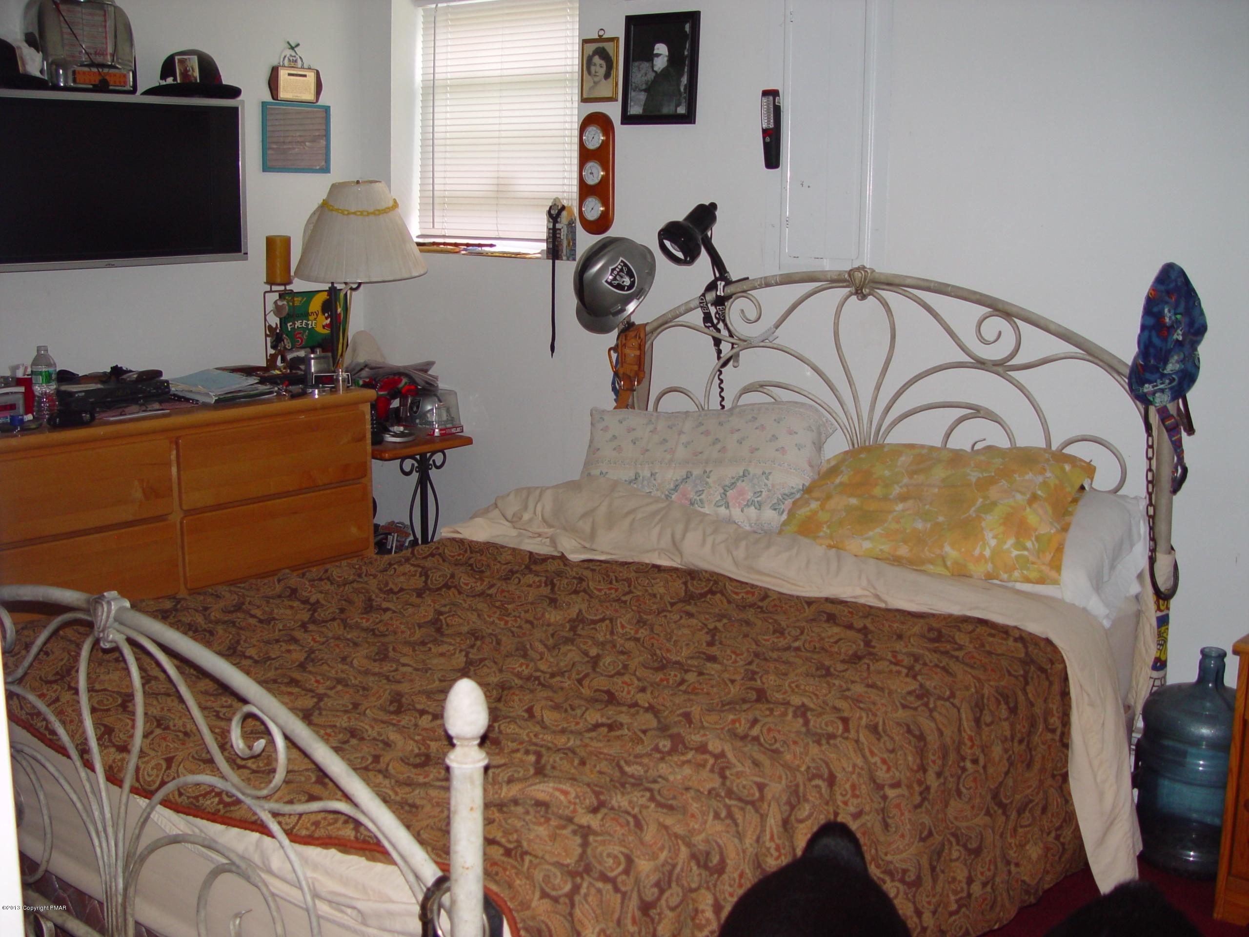 396 Good Times Road Kunkletown, PA 18058 - Photo 44 of 45 a bedroom with a bed and a flat tv screen on the dresser