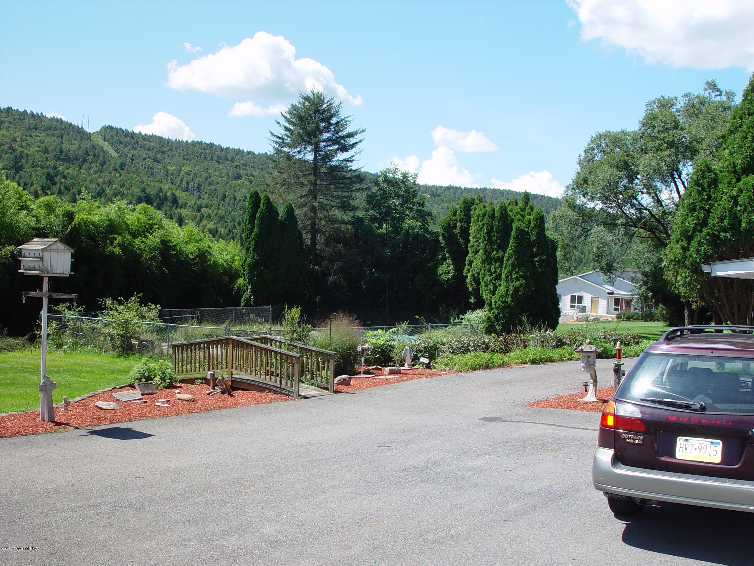 396 Good Times Road Kunkletown, PA 18058 - Photo 5 of 45 a view of backyard with swimming pool and green space