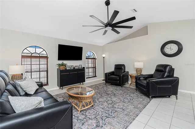 a living room with furniture a rug and a flat screen tv