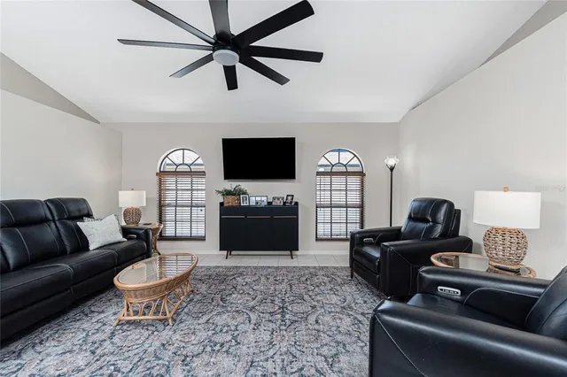 a living room with furniture a fireplace and a flat screen tv