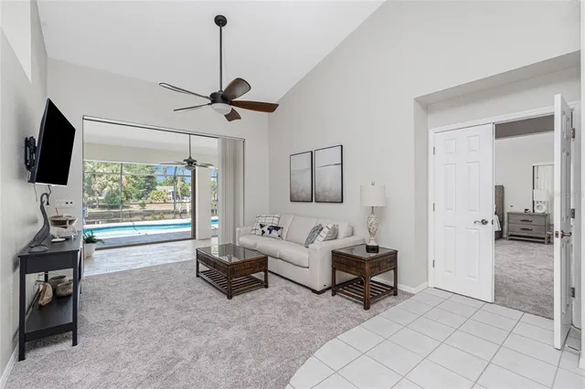 a living room with furniture and a ceiling fan