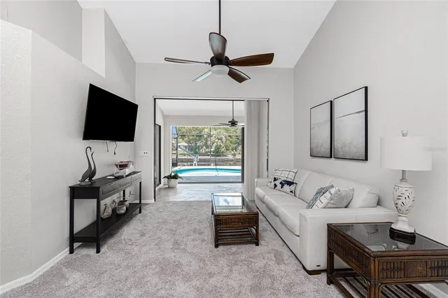 a living room with furniture a clock and a window