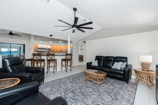 a kitchen with stainless steel appliances a dining table and chairs