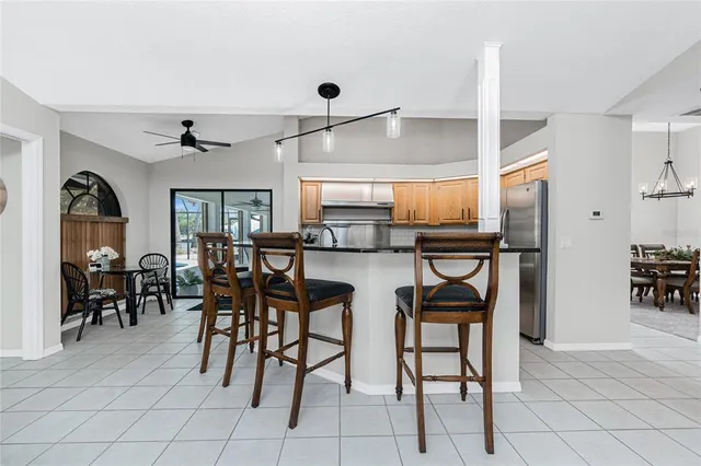 a kitchen with stainless steel appliances granite countertop a stove a refrigerator and a sink