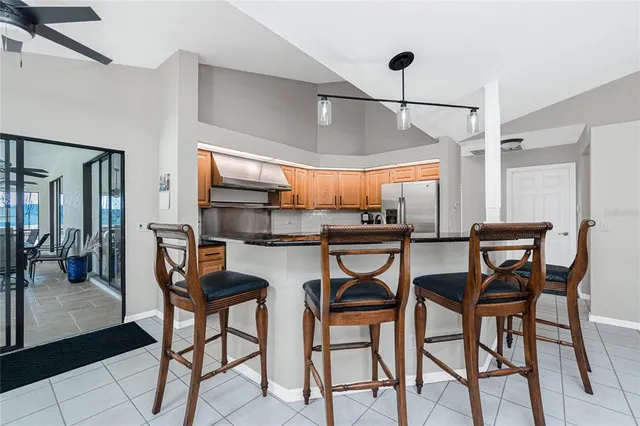 a kitchen with granite countertop a sink stainless steel appliances and cabinets