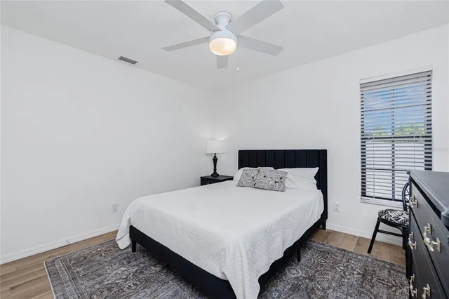 a bedroom with a large bed and a window