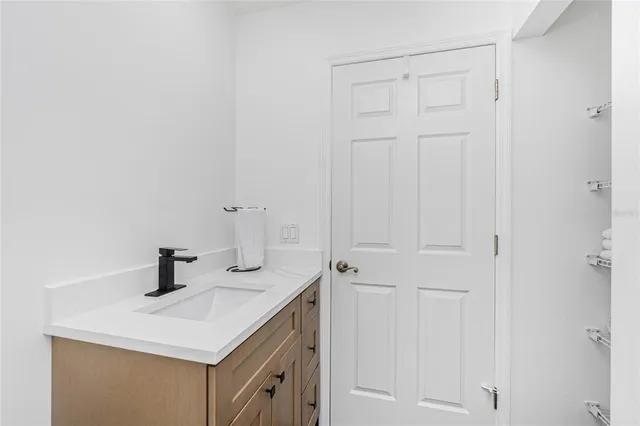 a view of a white building with swimming pool in front of it