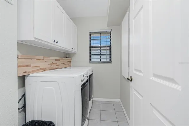 a view of swimming pool with a table and chairs
