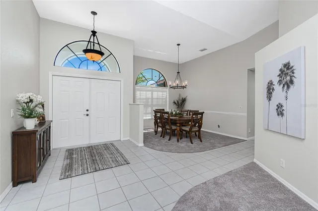 a view of dining room and kitchen with furniture wooden floor and a chandelier