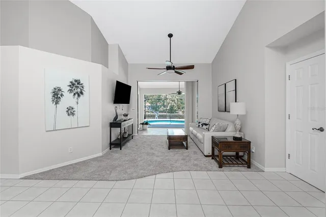 a living room with furniture a window and a flat screen tv