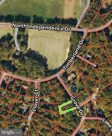 an aerial view of a red sign board with large trees