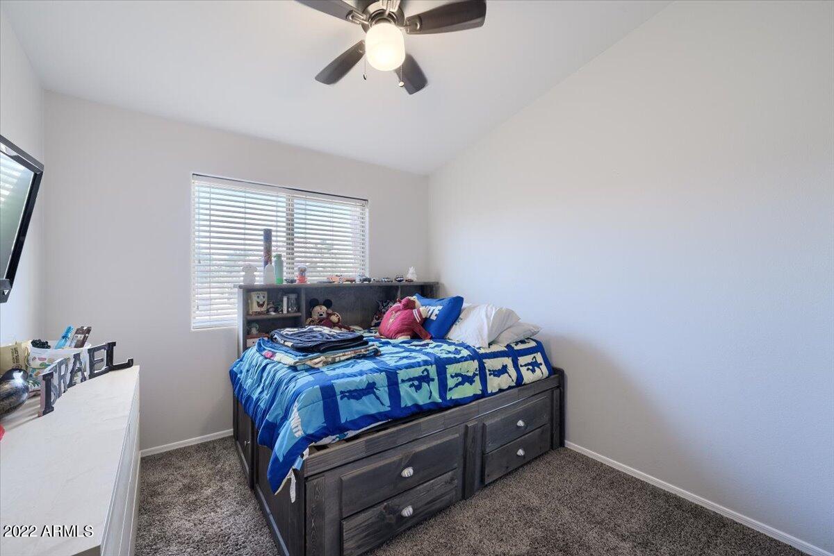 3889 East Timberline Road Gilbert, AZ 85297 - Photo 13 of 25 a bed room with furniture and a window