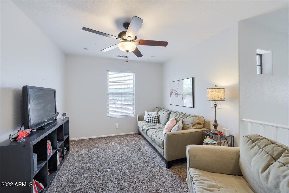 3889 East Timberline Road Gilbert, AZ 85297 - Photo 9 of 25 a living room with furniture and a flat screen tv
